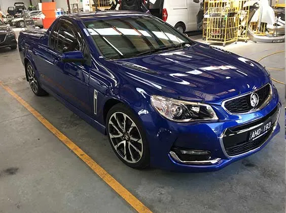 The same blue Holden ute after fallout removal, paint restored to gloss