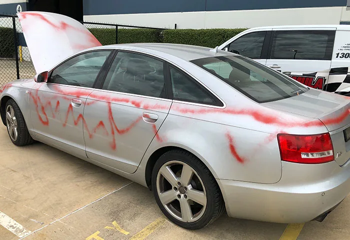 Cement splatter being removed from a vehicle bonnet