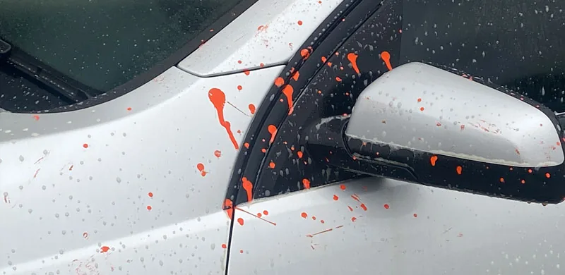 Graffiti paint being lifted from a painted surface